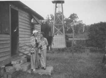 Annie Mitchell Hyde and Joyce Ford at the Eraring cottage. Monkey cages in background